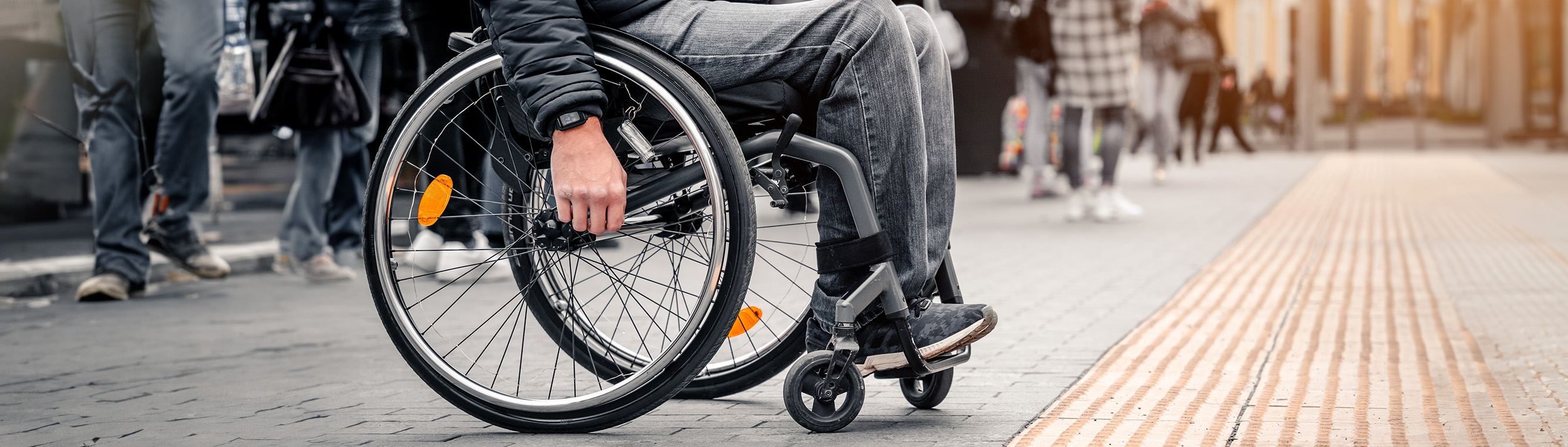 Person in wheelchair crossing the road.